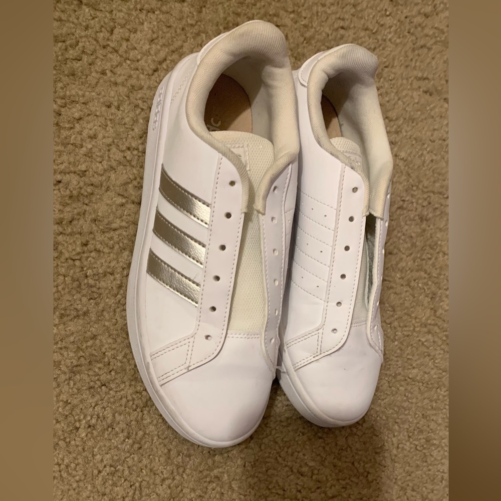White Adidas sneakers with gold stripes